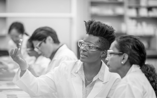 Two diverse female physicians consulting in a lab setting